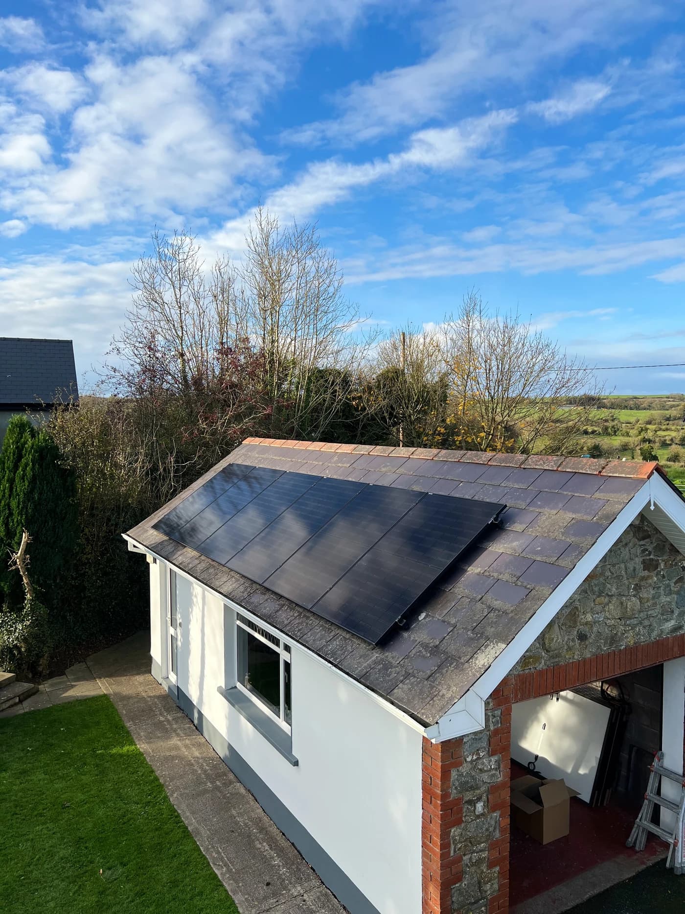 Supplied photograph of a slate-roofed outbuilding with solar panels